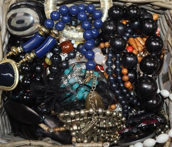 A group of assorted costume jewellery including necklaces and beads and a pair of opera glasses.